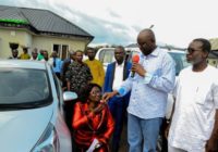 Governor Fayose watches as school principal kneels down to receive car gift from him